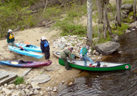 Photo of canoes on river bank