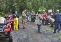 Photo of volunteers with all terrain vehicles and tools
