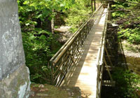 Photo of long bridge over wooded canyon