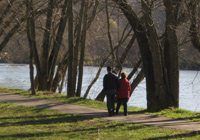 Photo of elderly couple walking along river