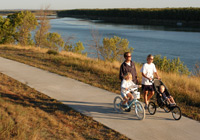 Photo of family on paved  trail above river