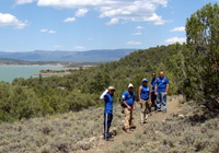 Photo of crew on dirt trail on dry slope