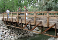 Photo of trail bridge with rock bank protection