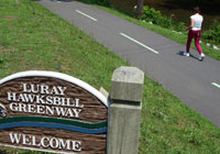 Photo of trail sign with asphalt trail