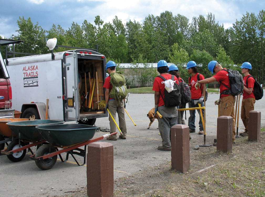 Photo of volunteers getting tools out of the tool trailer