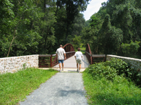 Photo of walkers about to cross a trail bridge