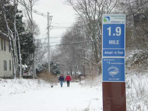 Photo of people walking on snowy trail