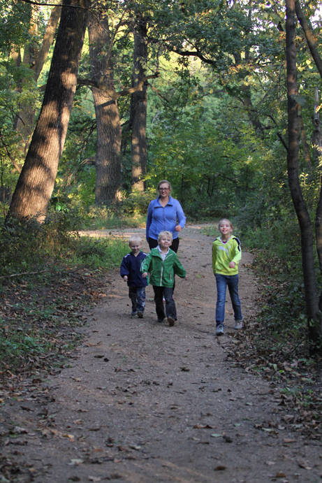 Photo of people walking on wooded trail