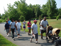 Photo of group of people walking on a paced trail