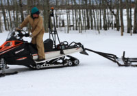 photo of snowmobile pulling groomer