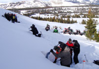 photo of snowmobile and people digging in snow